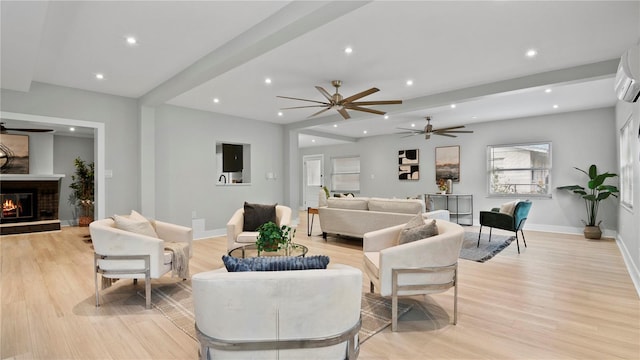 living room featuring ceiling fan and light hardwood / wood-style flooring