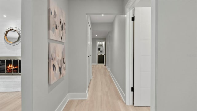 hallway with light hardwood / wood-style flooring