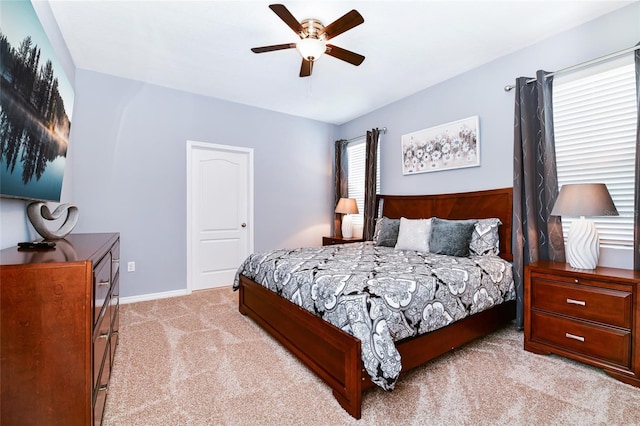 bedroom with ceiling fan and light colored carpet