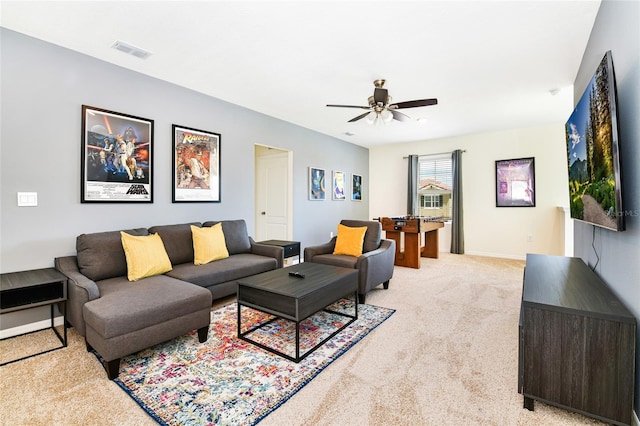 carpeted living room featuring ceiling fan