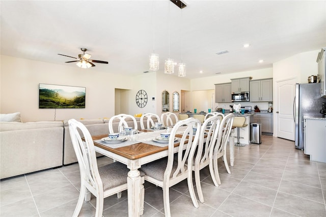 dining room with light tile patterned flooring and ceiling fan