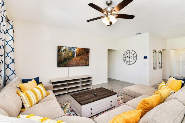 living room with ceiling fan and light tile patterned floors