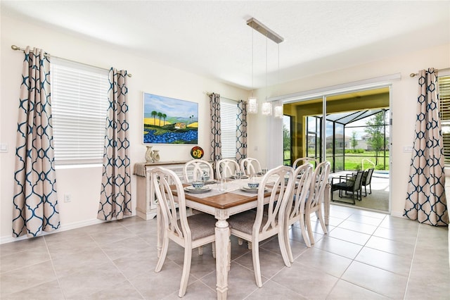 tiled dining area with a wealth of natural light and a textured ceiling