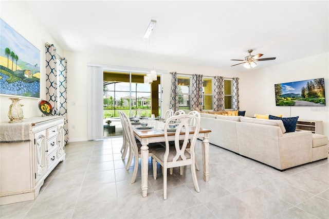 tiled dining space with ceiling fan