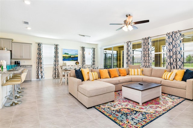 living room with light tile patterned floors and ceiling fan