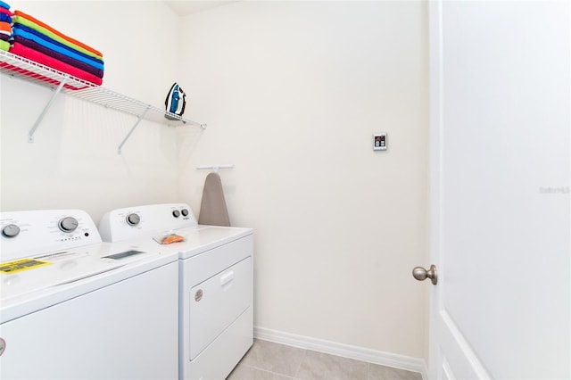 washroom with separate washer and dryer and light tile patterned floors