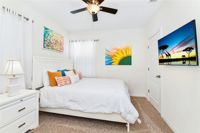 bedroom featuring light carpet and ceiling fan