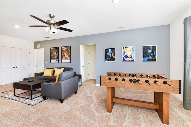 game room with light carpet and ceiling fan