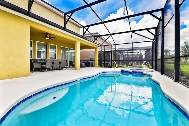 view of pool with a patio, a lanai, ceiling fan, and an in ground hot tub