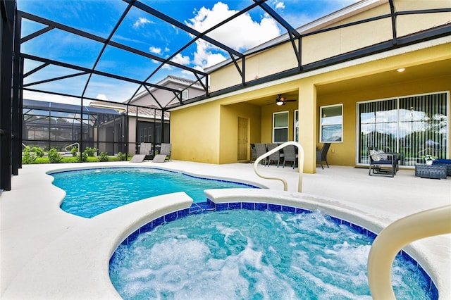 view of pool featuring glass enclosure, ceiling fan, and a patio area