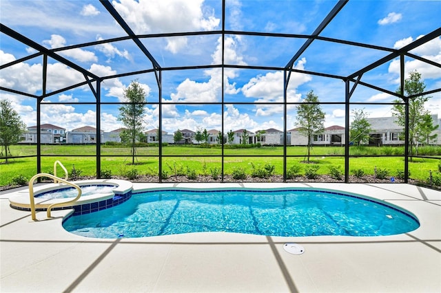 view of pool with an in ground hot tub, a lanai, a lawn, and a patio