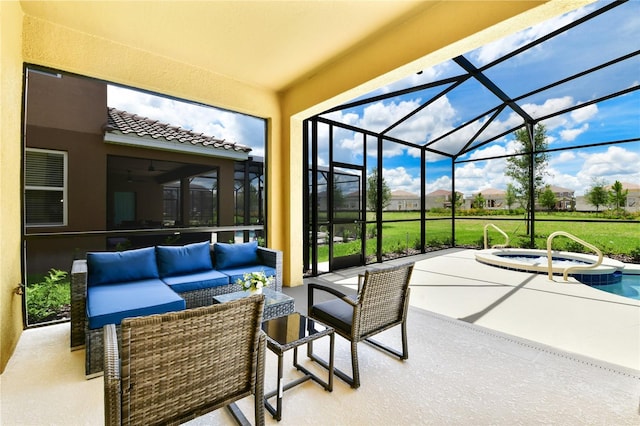 view of patio / terrace featuring an in ground hot tub, a lanai, and an outdoor hangout area