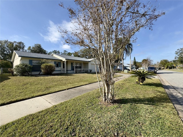 ranch-style home featuring a front yard