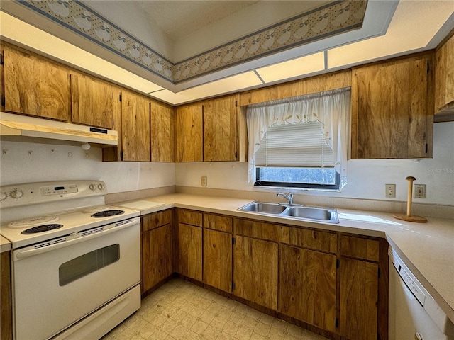 kitchen featuring white appliances and sink