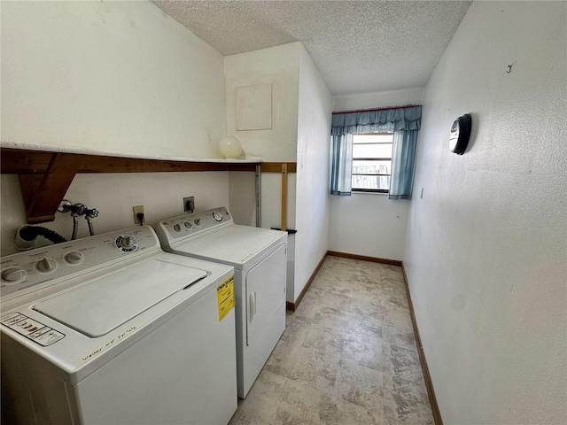 laundry area with washer and dryer and a textured ceiling