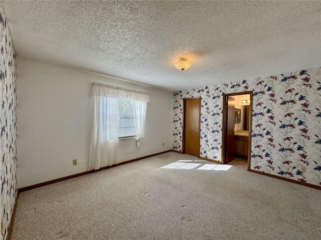 unfurnished room with light carpet and a textured ceiling