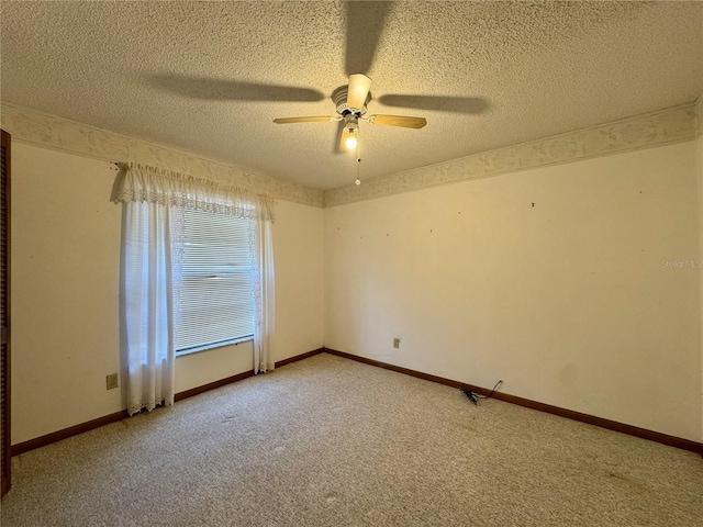 spare room with ceiling fan, carpet flooring, and a textured ceiling