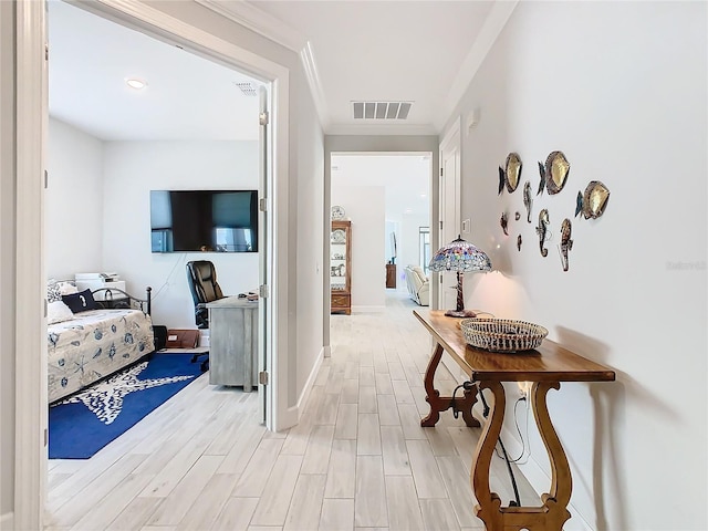 hall with crown molding and light wood-type flooring