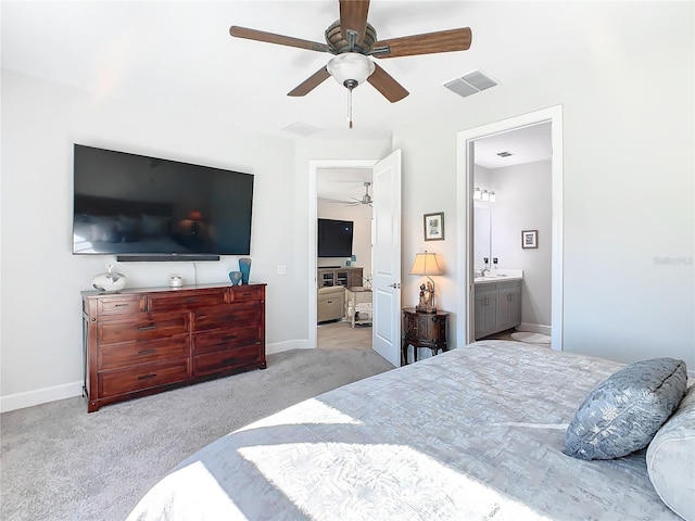 carpeted bedroom featuring connected bathroom, sink, and ceiling fan