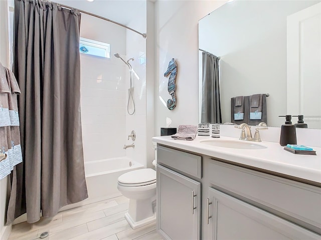 full bathroom featuring shower / tub combo with curtain, vanity, and toilet