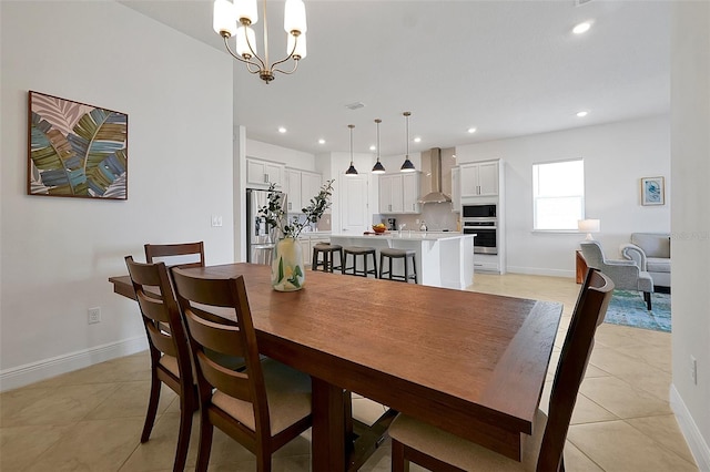 dining space featuring light tile patterned flooring and a chandelier