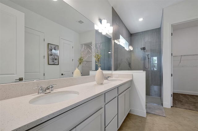 bathroom featuring tile patterned floors, vanity, and a shower with shower door