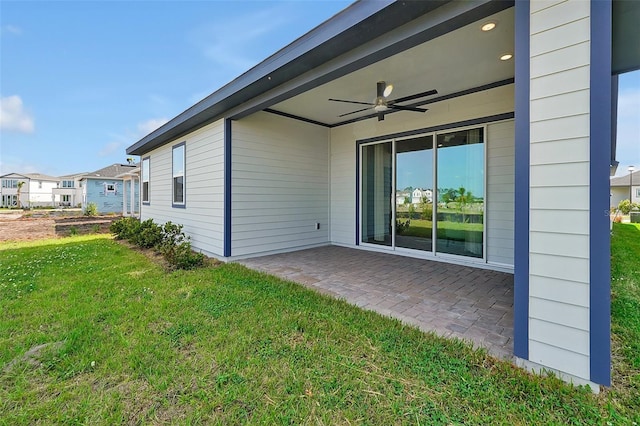 exterior space with a yard, ceiling fan, and a patio area