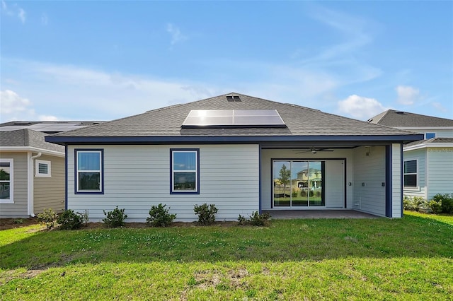 back of property featuring ceiling fan, a lawn, a patio, and solar panels