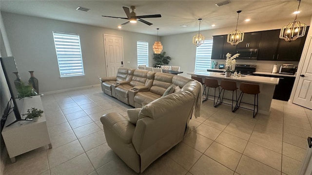 living room with light tile patterned floors, a wealth of natural light, and sink