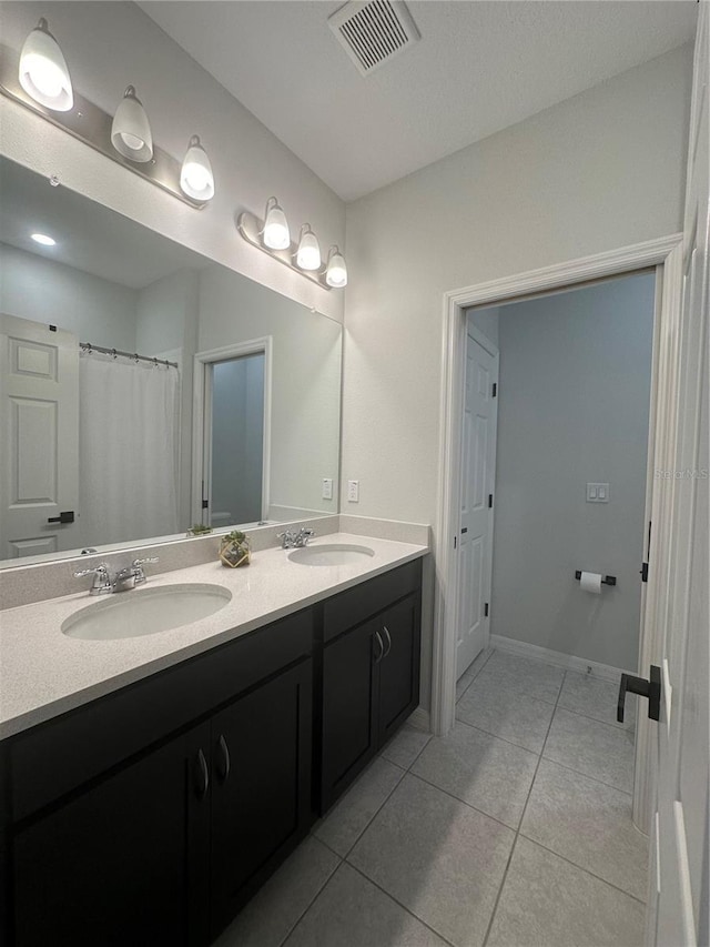 bathroom featuring vanity, tile patterned floors, and walk in shower