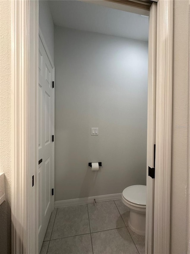 bathroom featuring toilet and tile patterned flooring