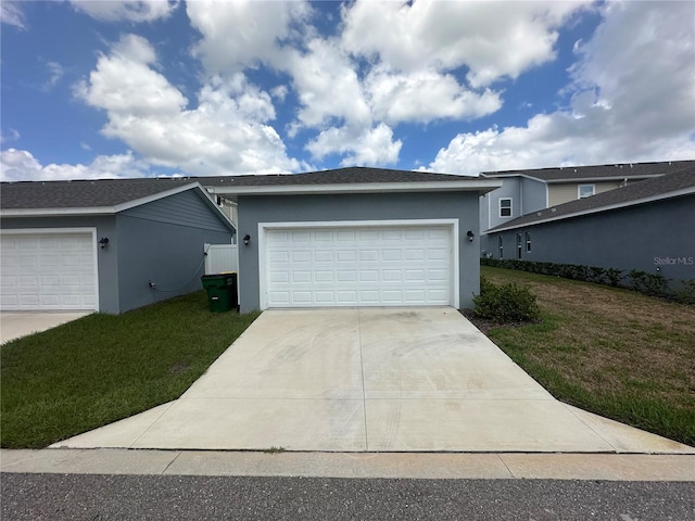 view of front of property with a garage and a front yard