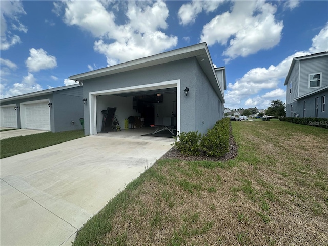 view of side of property with a garage and a yard