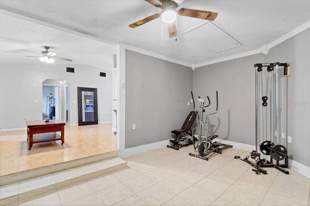 exercise room with crown molding, lofted ceiling, light tile patterned floors, and a textured ceiling