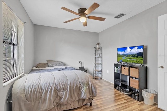 bedroom with ceiling fan and hardwood / wood-style floors