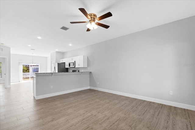 unfurnished living room featuring ceiling fan