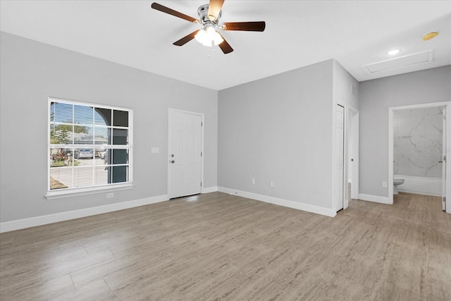 empty room with light hardwood / wood-style flooring and ceiling fan