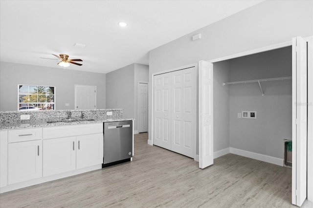 kitchen featuring sink, ceiling fan, light stone counters, white cabinets, and stainless steel dishwasher