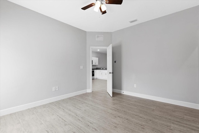 empty room with hardwood / wood-style flooring and ceiling fan