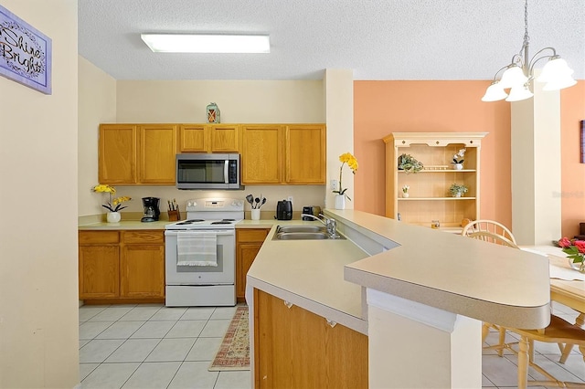 kitchen with light tile patterned flooring, hanging light fixtures, electric range, kitchen peninsula, and a textured ceiling