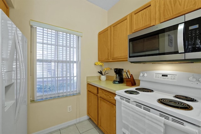 kitchen featuring white appliances and light tile patterned floors