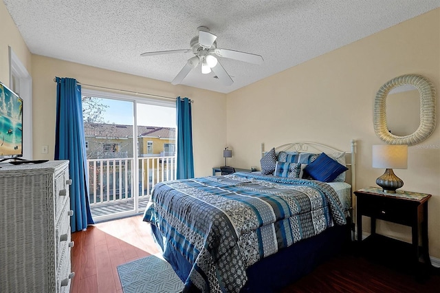 bedroom with dark wood-type flooring, access to outside, a textured ceiling, and ceiling fan