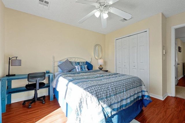 bedroom with wood-type flooring, a closet, and ceiling fan