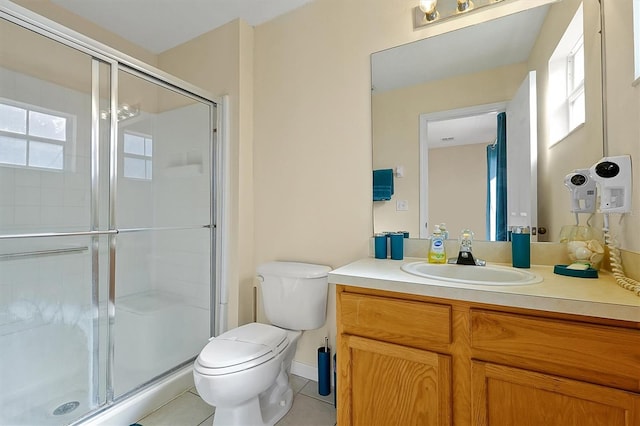 bathroom featuring a shower with door, vanity, tile patterned floors, and toilet