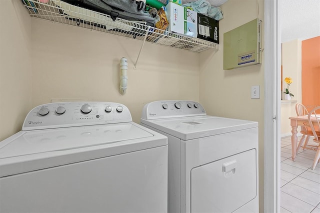 washroom with separate washer and dryer and light tile patterned floors