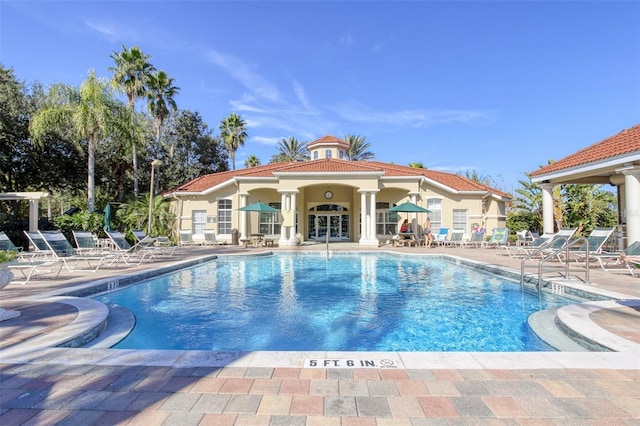 view of swimming pool featuring a patio and an outdoor structure