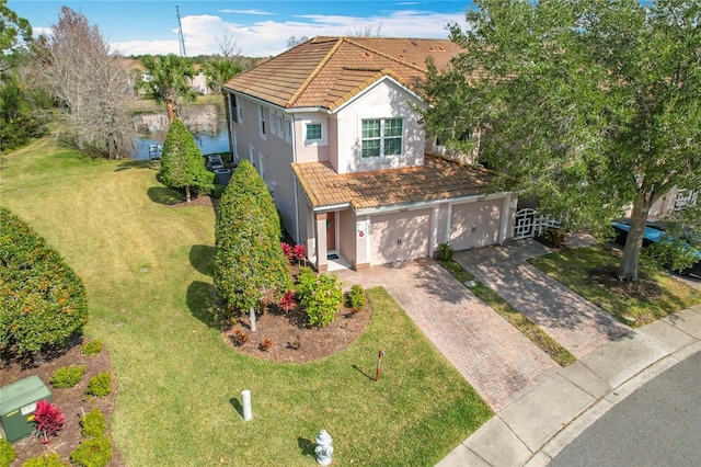 view of front of home featuring a garage and a front yard