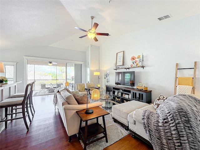 living room featuring ceiling fan, lofted ceiling, and dark hardwood / wood-style flooring