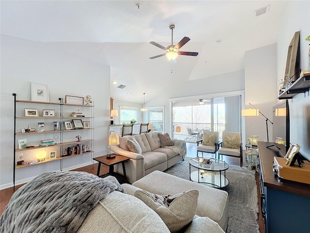 living room with lofted ceiling, ceiling fan, dark hardwood / wood-style floors, and a healthy amount of sunlight