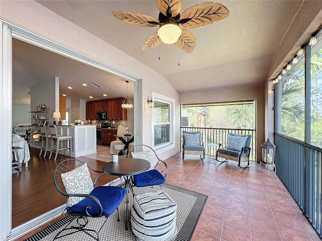 sunroom / solarium with lofted ceiling and ceiling fan